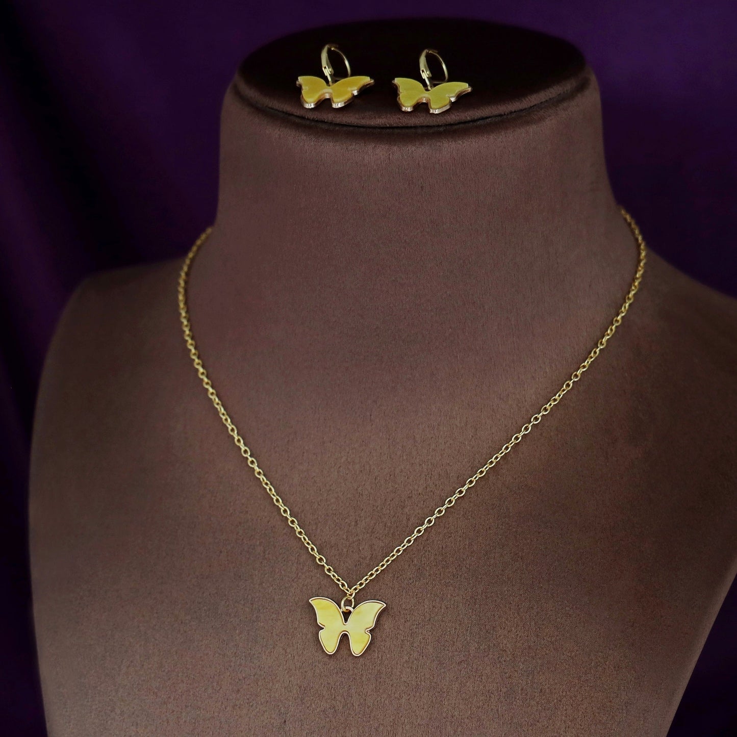 Butterfly neckpiece with hoop earrings