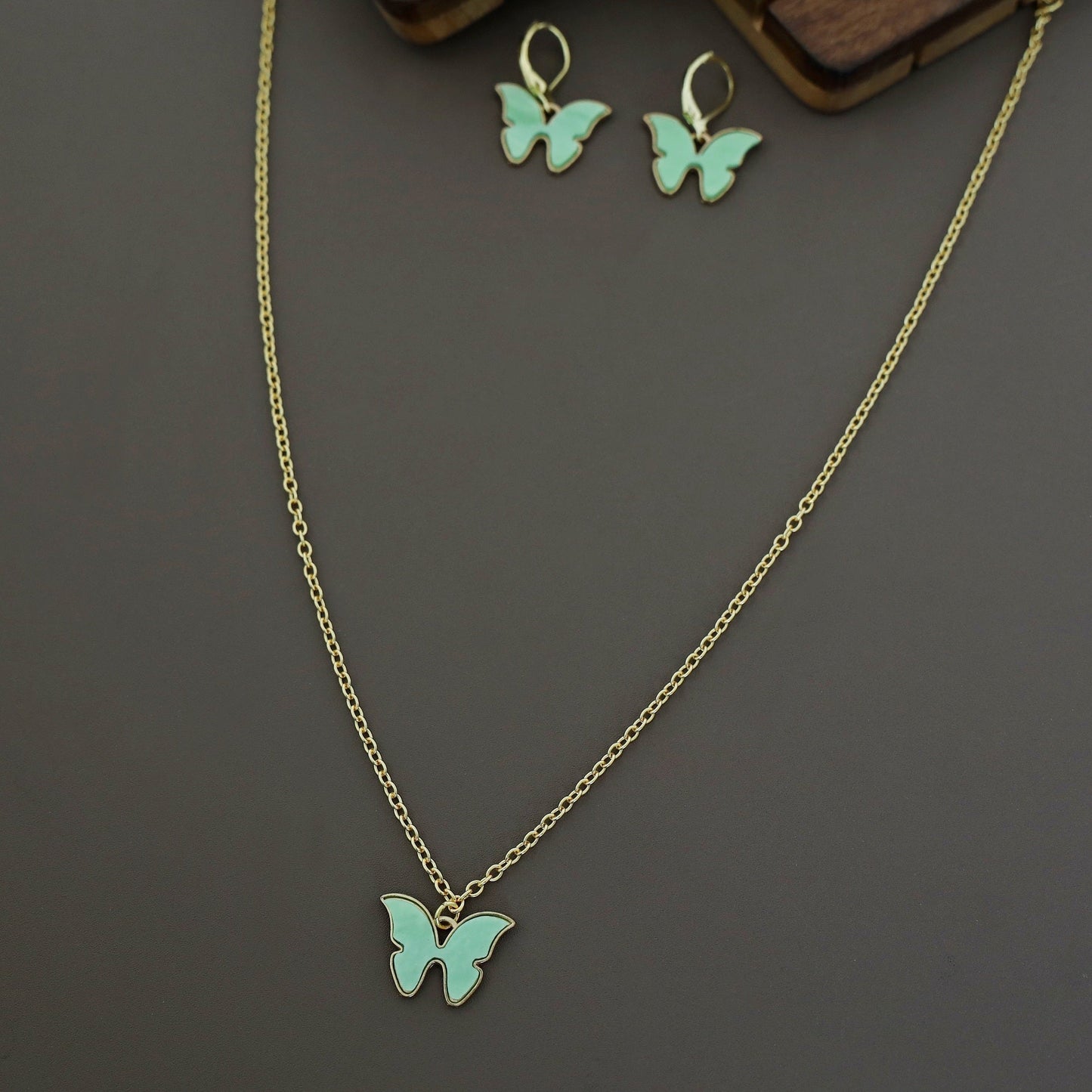 Butterfly neckpiece with hoop earrings