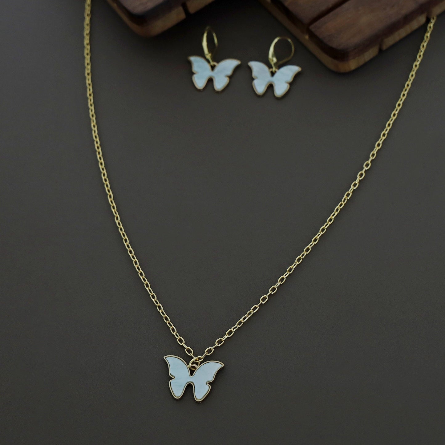 Butterfly neckpiece with hoop earrings